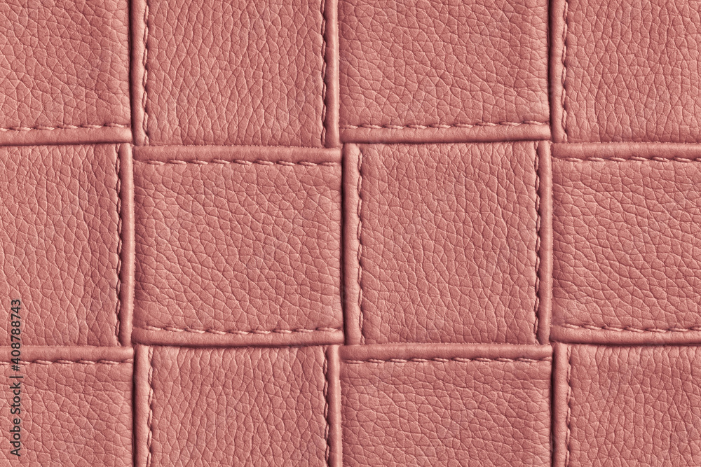 Fototapeta premium Texture of dark pink and rose leather background with square pattern and stitch.