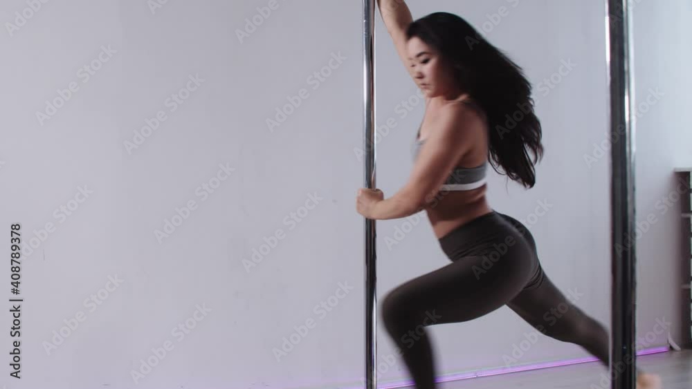 Fitness training - a woman showing a basic spin on the pole Fitness training - a woman showing a basic spin on the pole