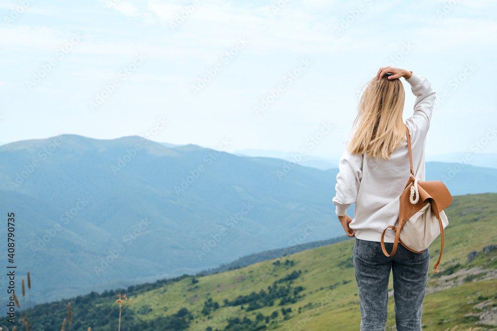 Naklejka premium Girl enjoy scenics view on valley. Beautiful nature landscape in mountains. Hiking journey on tourist trail. Outdoor adventure. Travel and exploration. Healthy lifestyle, leisure activities