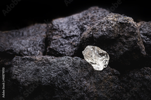 Rough diamond, uncut gemstone, mine bottom. Concept of mining and extraction of rare ores. photo