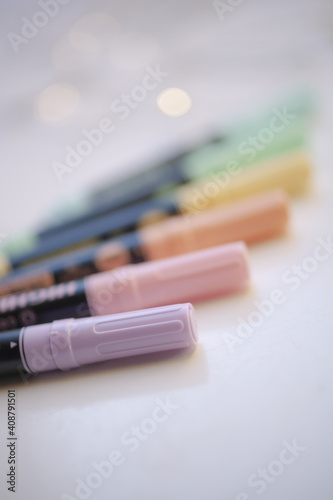 Set of highlighter pens for marking important messages in pastel rainbow colors with blurred background