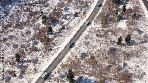 Aerial view of cars driving at road surrounded by snow at mountain, Zagreb.