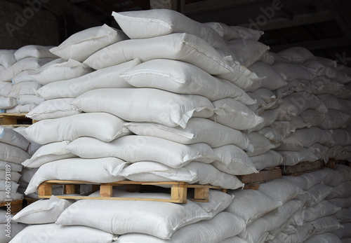 A production warehouse with bags stacked on pallets, a grain processing plant, an ingredient for the food industry.