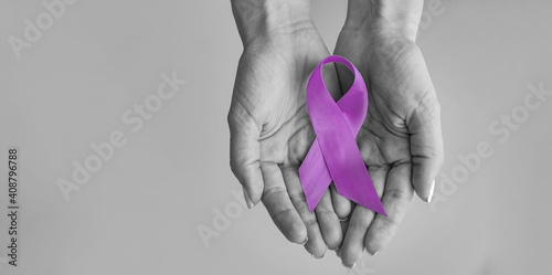 World cancer day inscription. healthcare and medicine concept - girl hands holding Purple cancer awareness ribbon. 4 february day