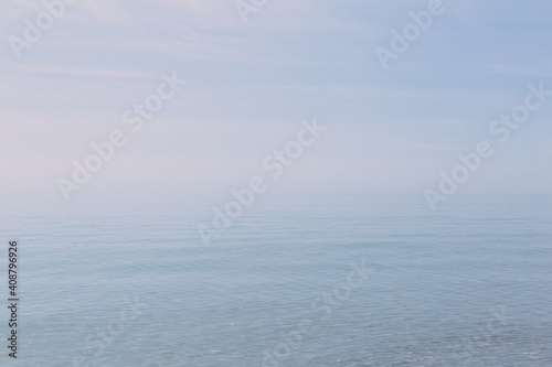 Clear and blue sea with a soft horizon