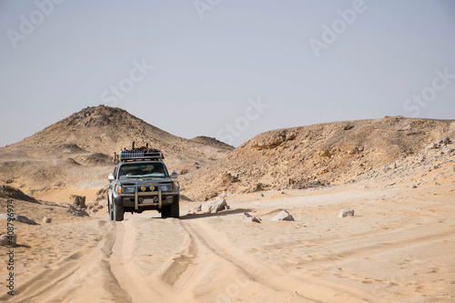 truck in the desert of bahariya national park egypt. Offroad exploring extreme environment. Car tracks and stone hills. Adventure scene, sahara safari. Extreme travel destinations.