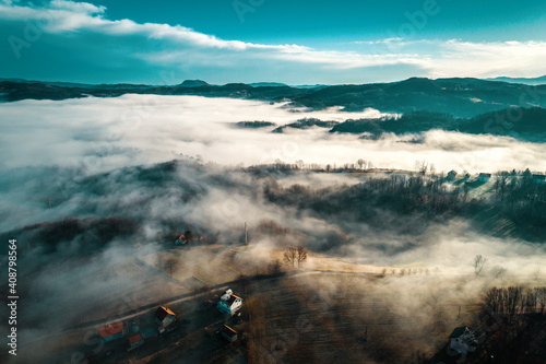 Fototapeta Naklejka Na Ścianę i Meble -  Aerial view of foggy sunrise in Bosnian countryside