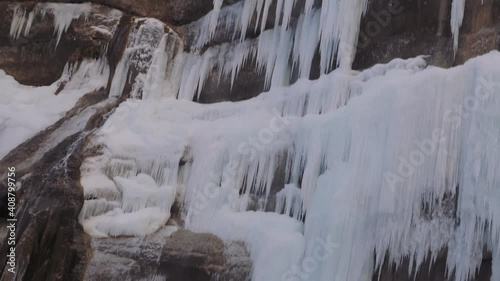 Chegem waterfall in the Caucasus Mountains in winter. The water froze into long icicles.