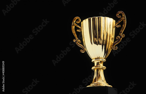 Shiny golden trophy cup with copy space on black background. Champion award for sports game competition or contest prize. Victory and Success concept. reward and pride of winner. great achievement.