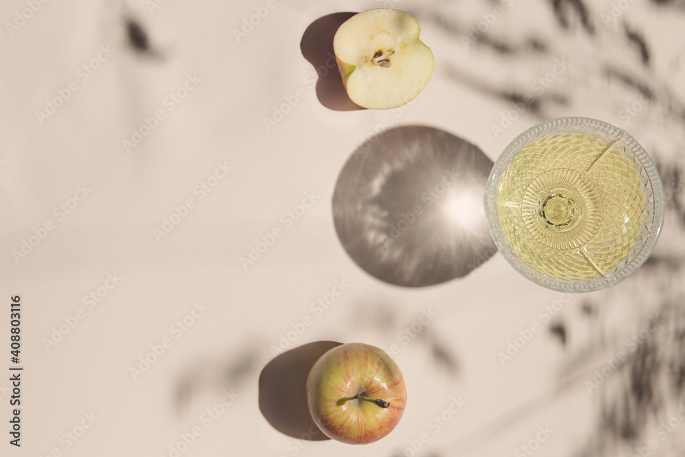 Summer still life composition made of apples and glass on pastel background white cloth. Creative layout. Freshness concept. Top view. Flat lay. Copy space