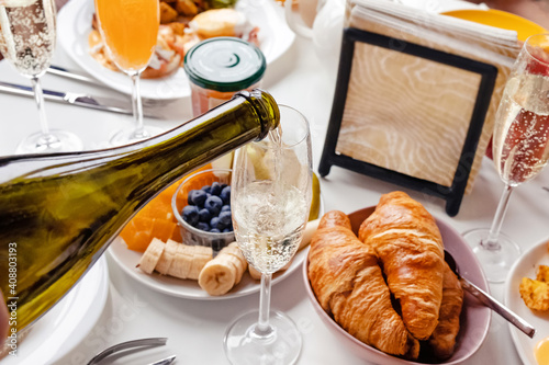 Pouring champagne to the glass close-up.