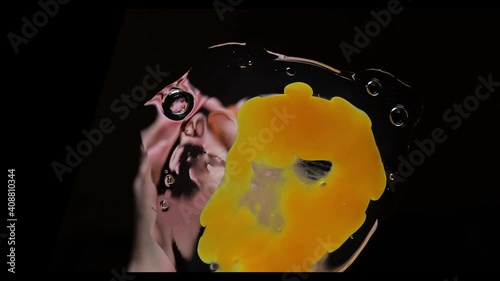 Cooking an omelette with fresh eggs, a scene when an egg is falling in the cooking surface on a black background, view from above photo