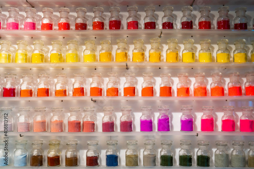 Row of colorful dry powder in glass bottle
