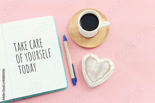 self care concept. notebook with text over pink background photo