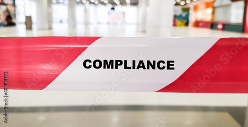 COMPLIANCE on a red ribbon background in a closed the room