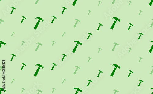 Seamless pattern of large and small green hammer symbols. The elements are arranged in a wavy. Vector illustration on light green background
