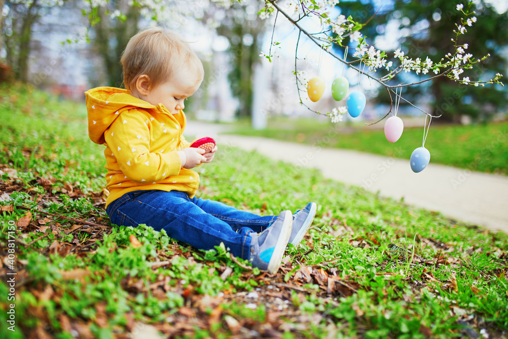 Cute little one year old girl playing egg hunt on Easter Cute little one year old girl playing egg hunt on Easter