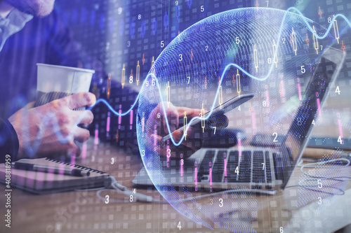 Double exposure of man's hands holding and using a phone and financial graph drawing. Analysis concept.