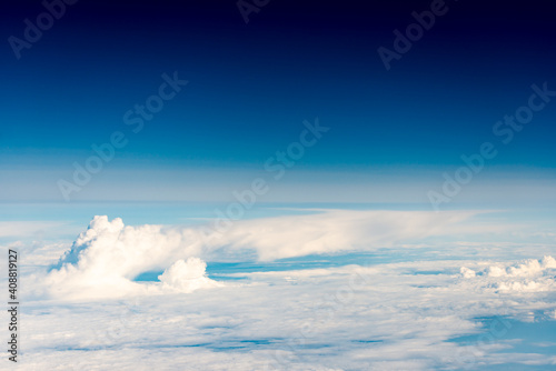 Clouds from the plane window. The world of aerial illusions at an altitude of 10 km