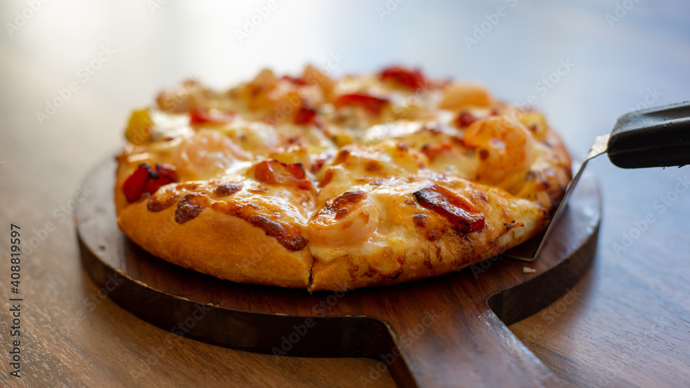 Seafood Italian Pizza slice on wood dish Seafood Italian Pizza slice on wood dish