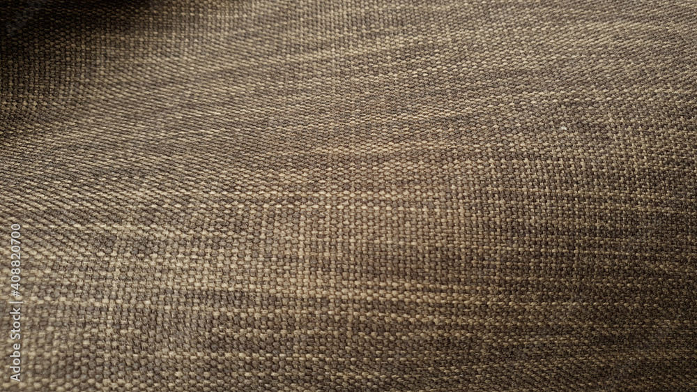 close up brown natural wavy sackcloth texture background. rough burlap canvas wallpaper with space for text.