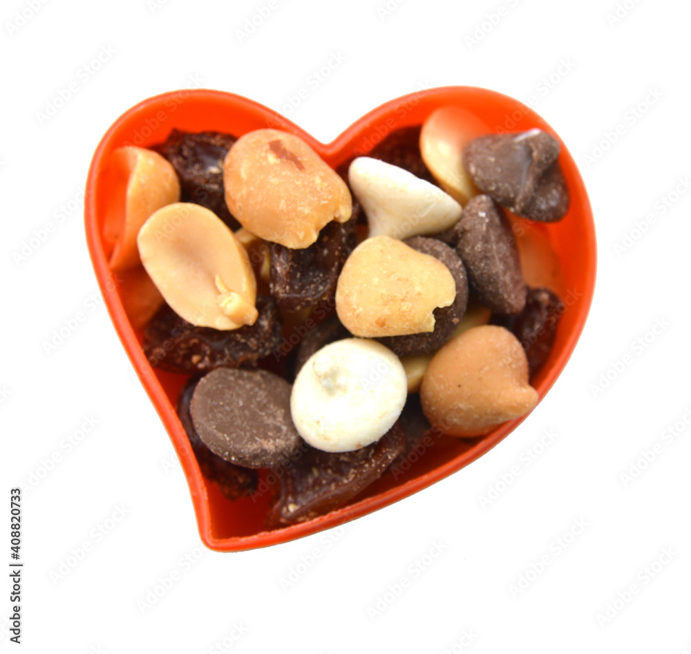 Mix nuts, dry fruits and grapes in bowl on a white background Mix nuts, dry fruits and grapes in bowl on a white background