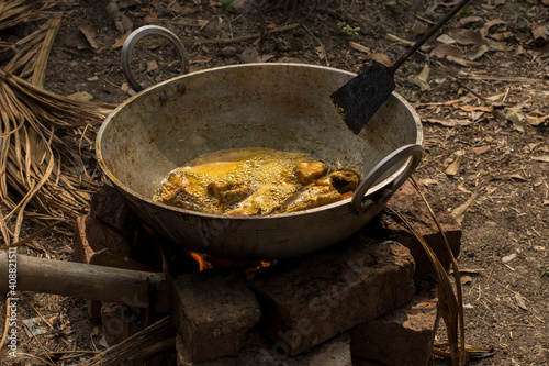 Cooking chicken preparation in a big kadai.