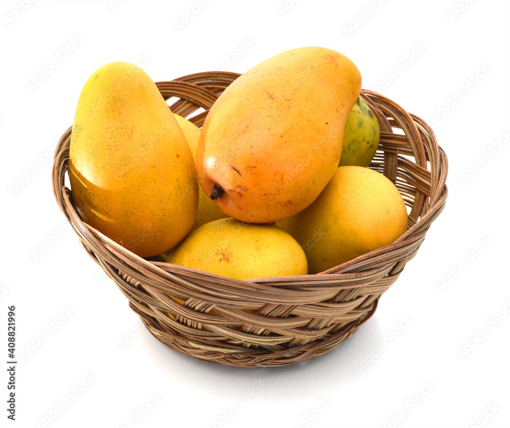 Yellow mango isolated in basket on a white background