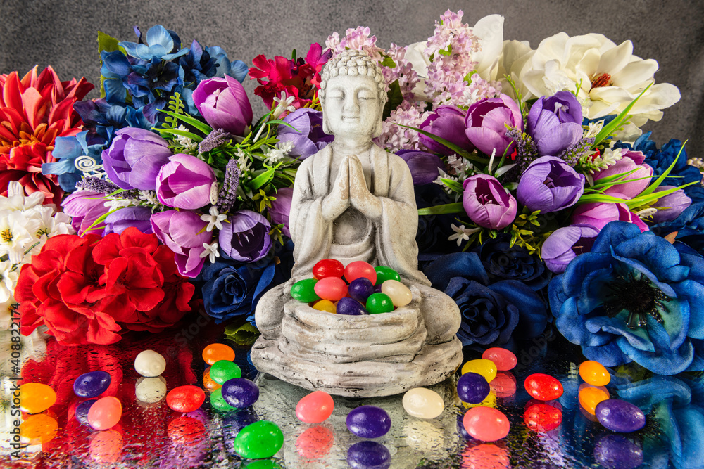Easter buddha surrounded by jelly beans and spring flowers