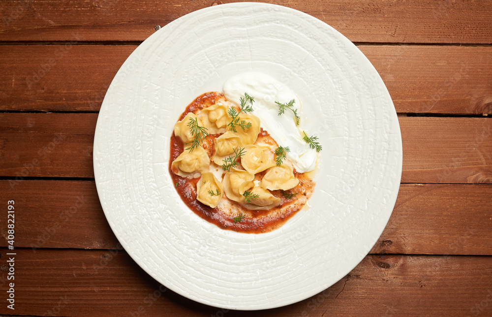 dumplings with meat and tomato paste on a plate