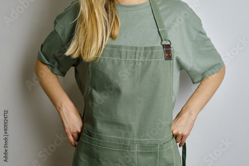 Fototapeta A woman in a kitchen apron