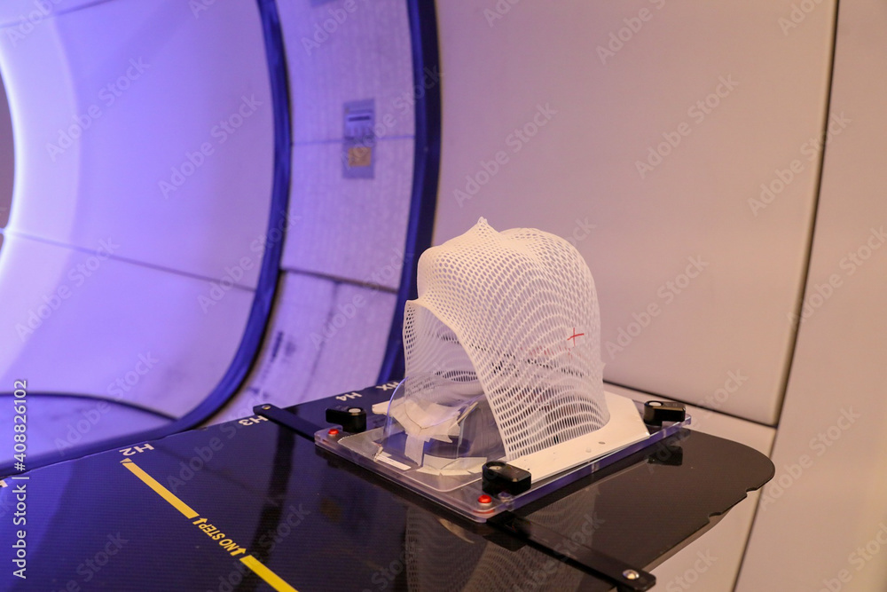 Patient Radiation proton therapy fixing mask showing laser lines for cancer cells in the brain Stock Photo | Adobe