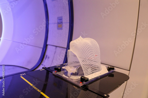 Patient Radiation proton therapy fixing mask showing laser lines for targeting cancer cells in the brain photo