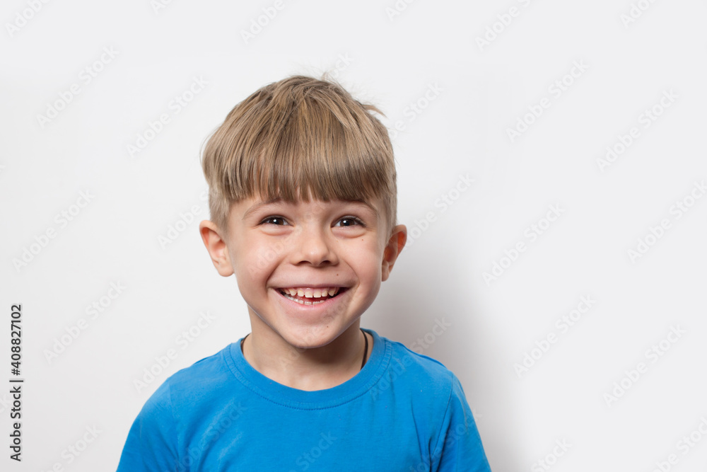 Portrait of cute little boy wearing blue t shirt isolated over white background Portrait of cute little boy wearing blue t shirt isolated over white background