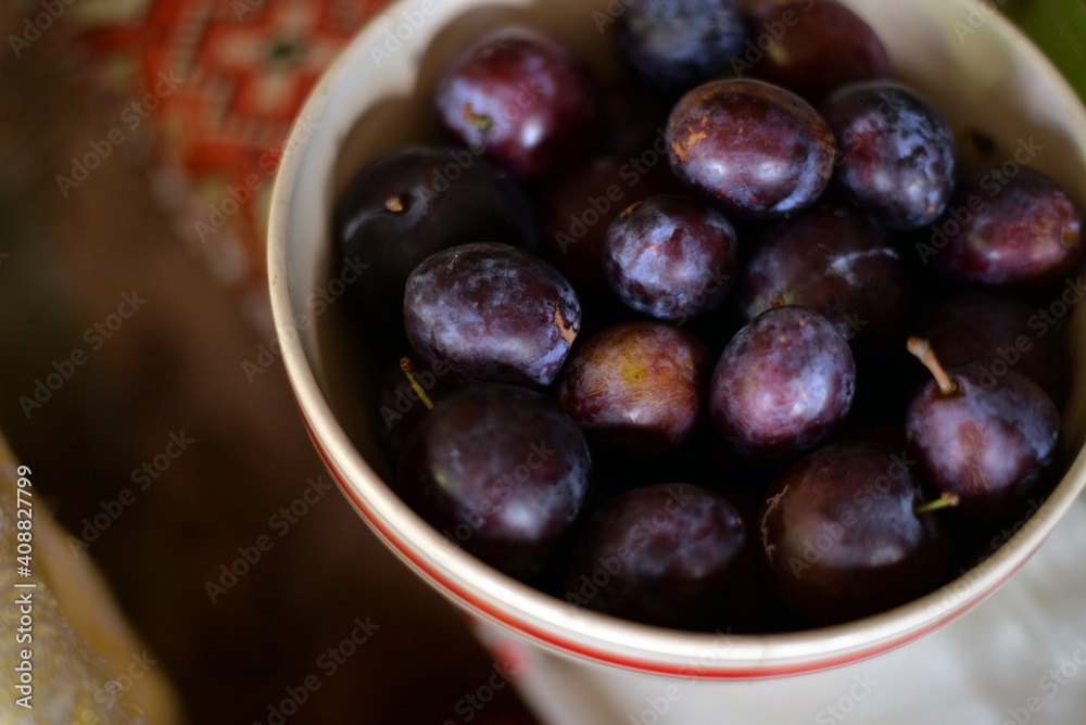 plums in a bowl on the table. organic tasty fruits from the orchard plums in a bowl on the table. organic tasty fruits from the orchard