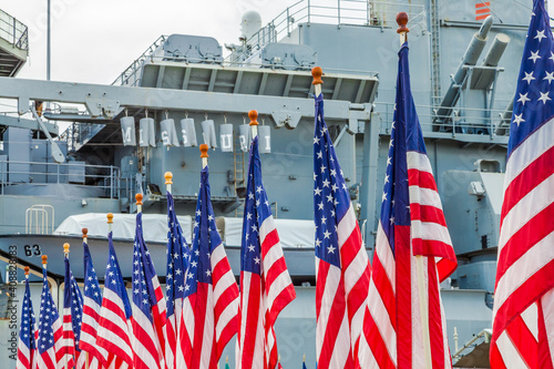 American flags with background Missouri Battleship in Pearl Harbor Honolulu Hawaii. Oahu island of United States. National historic patriotic monument.  photo