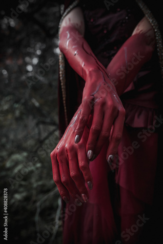 red bloody hands of a witch