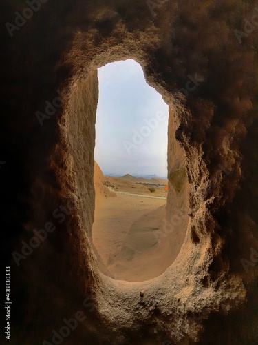 Scenery through a hole in a cave.
