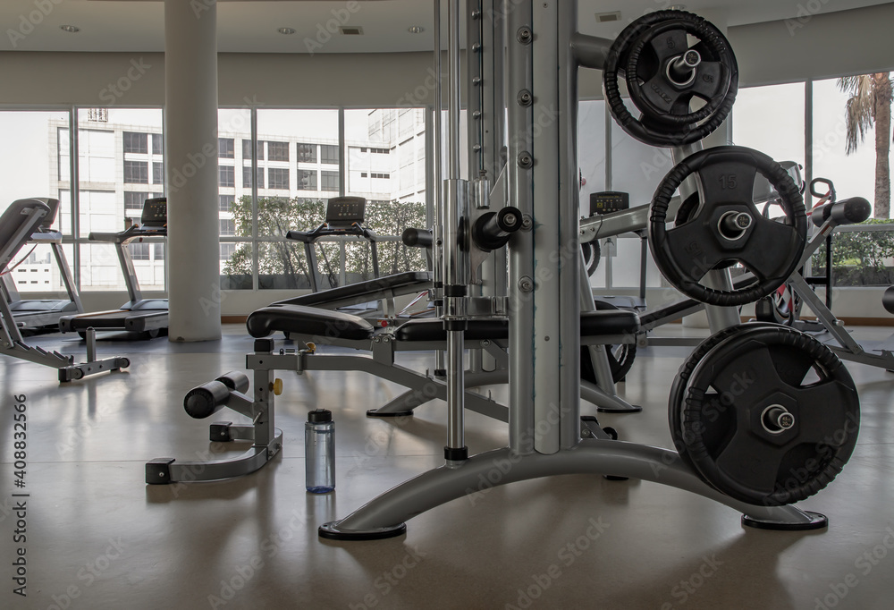 Obraz premium Within gym or fitness studio with modern fitness equipment for fitness events and more. Modern of gym interior with equipment. Sports equipment in the gym. Selective focus.
