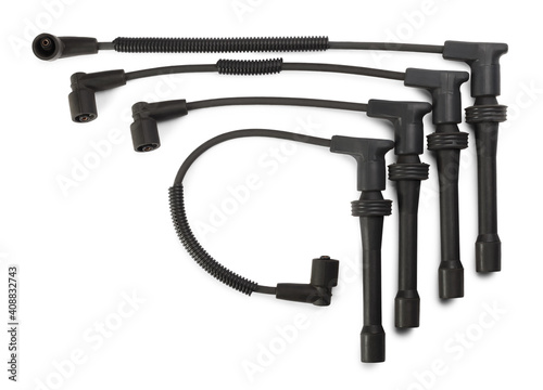 Black ignition wires of a high voltage for spark plugs isolated on white background. Car parts. Top view.