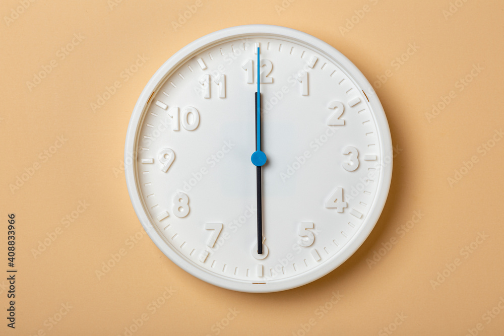 white wall clock with blue second hand show six o'clock white wall clock with blue second hand show six o'clock