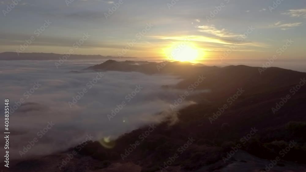 Flying over the edge of the fog during sunrise Flying over the edge of the fog during sunrise