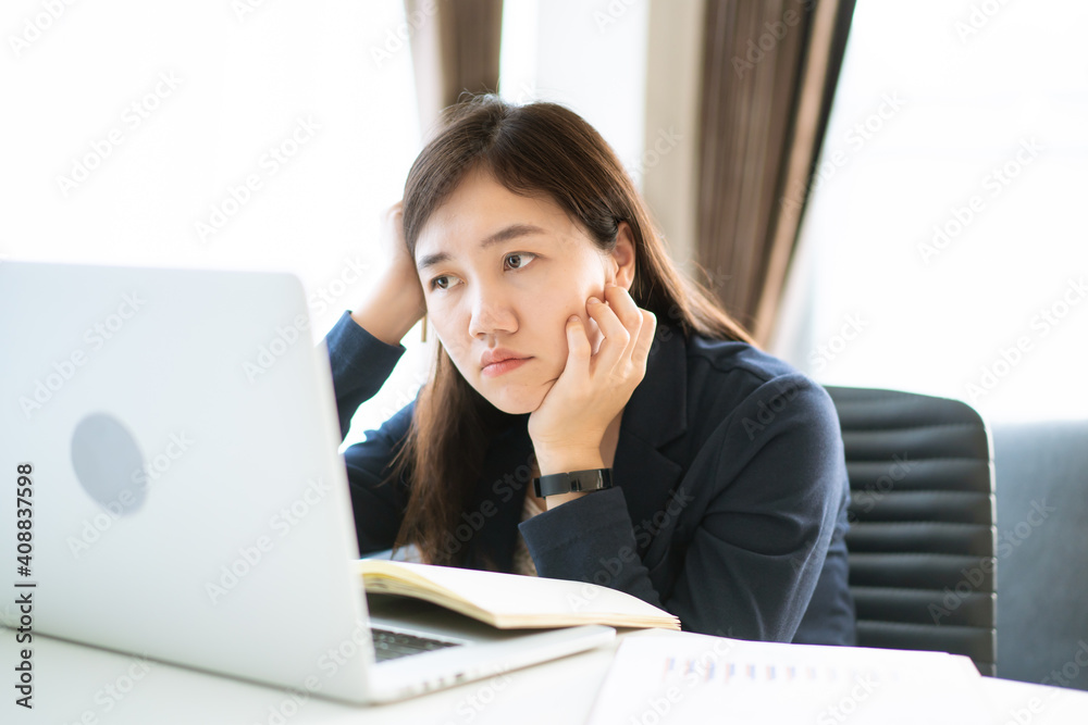 Stressful Asian businesswoman working at the office with suffer and unhappy emotion. Stressful Asian businesswoman working at the office with suffer and unhappy emotion.