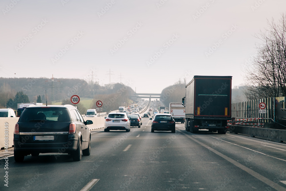 cars on the highway. Traffic Jam on German highway. Lots of cars on a wide German Autobahn on a rainy day with gray sky cars on the highway. Traffic Jam on German highway. Lots of cars on a wide German Autobahn on a rainy day with gray sky
