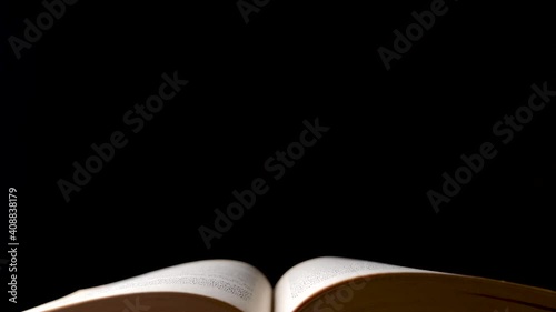 Wallpaper Mural Dolly shot over open old book isolated on black background Torontodigital.ca