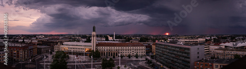 panorama view of city with storm and sunset