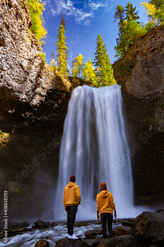 Wells Gray British Colombia Canada, couple on vacation visit spectacular water flow hikingof Helmcken Falls on the Murtle River in Wells Gray Provincial Park Clearwater, British Columbia,  photo