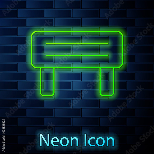 Glowing neon line Sauna wood bench icon isolated on brick wall background. Vector.