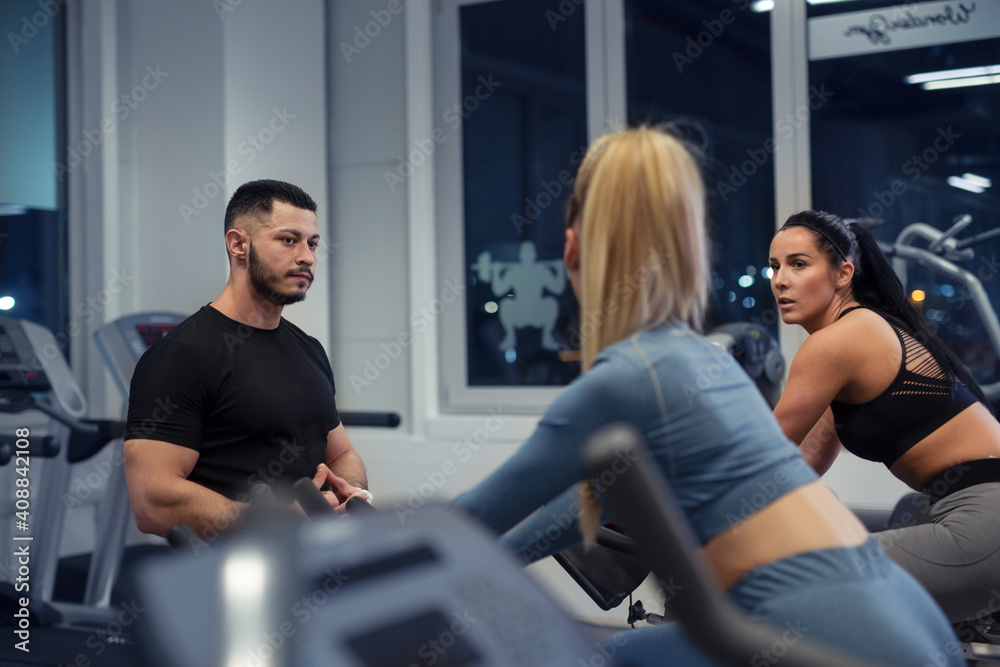 Personal trainer on weights lifting training with client