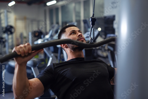 Bodybuilder working out in gym with determination